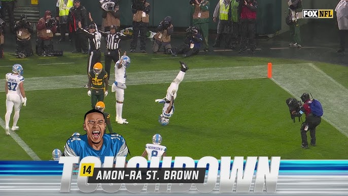 Amon-Ra St. Brown celebrating a Detroit Lions touchdown with an acrobatic end zone celebration